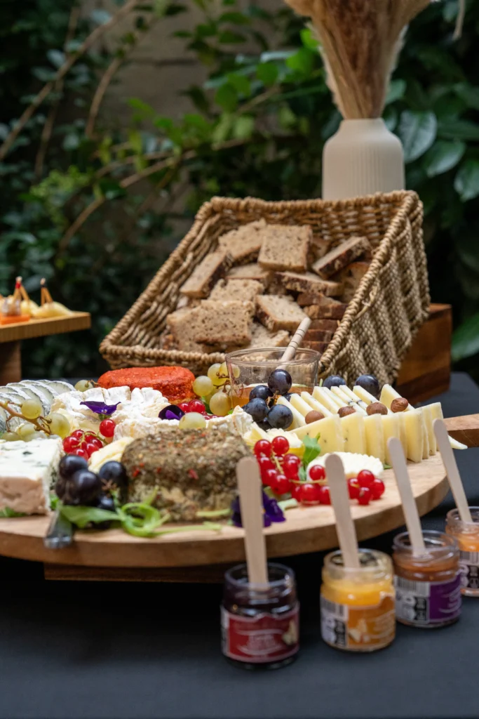 Buffet de fromages accompagné de pains, fruits et confitures pour un événement d’entreprise
